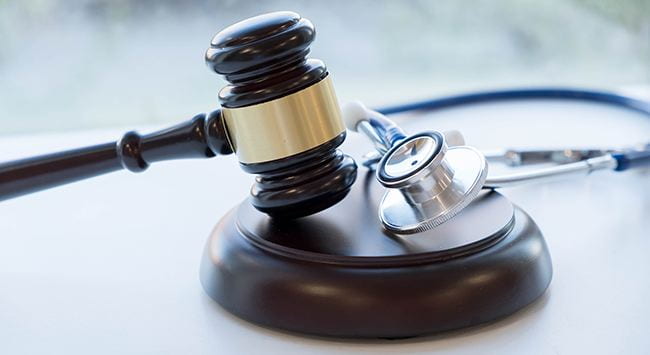 Gavel and stethoscope representing health law