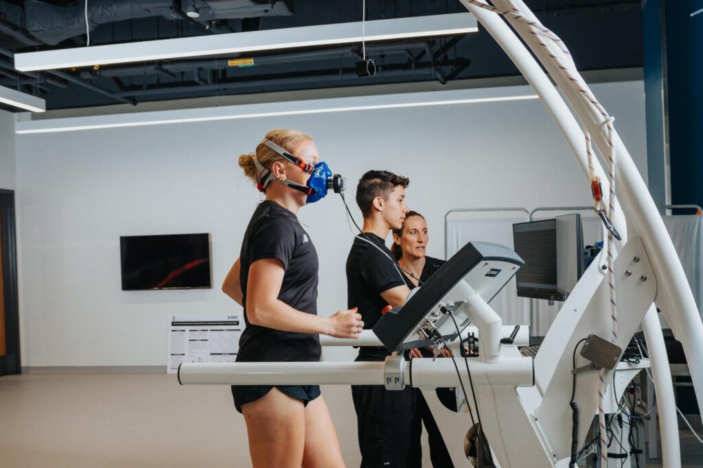Human performance lab research being conducting with a track athlete on a treadmill.